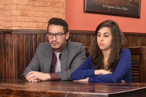 unhappy couple sitting at table